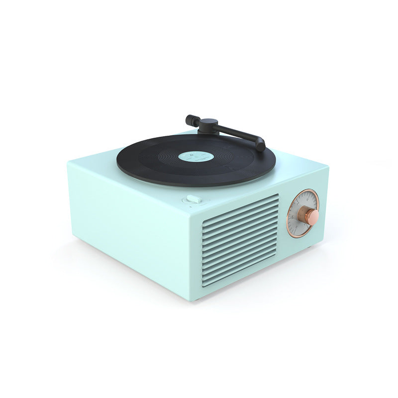 Vintage mint green wireless Bluetooth speaker with a record player design and rotary dial.