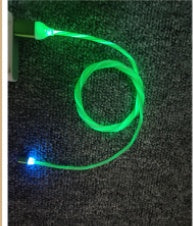Glowing green Magnetic Circular Magnetic Streamer Charging Cable showing a vibrant light-up effect for easy night charging.